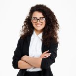Picture of cheerful curly business girl wearing glasses over white background